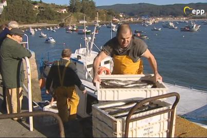 Two fishermen working on boat